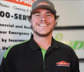 head shot of male crew chief in SERVPRO shirt smiling wearing a hat