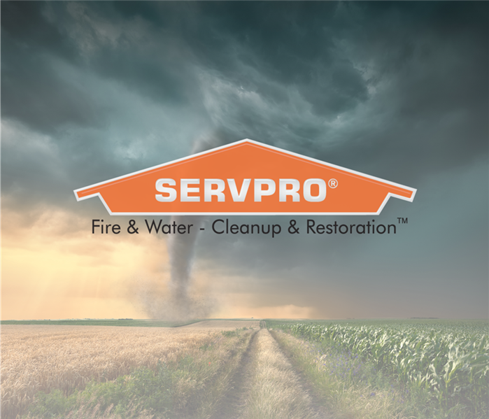 TORNADO GOING THROUGH A FIELD WITH THE SERVPRO LOGO OVER TOP